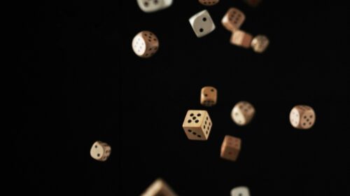 Dice falling on a black background.